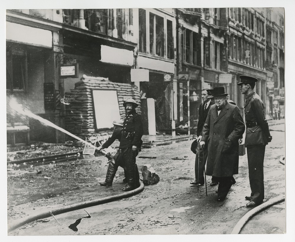 Photograph of Winston Churchill inspecting bomb damage in London, 1940.